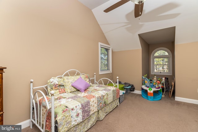 carpeted bedroom with vaulted ceiling and ceiling fan