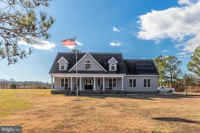 cape cod-style house featuring a front yard and a porch