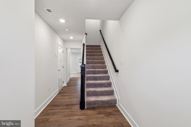 stairs featuring wood-type flooring