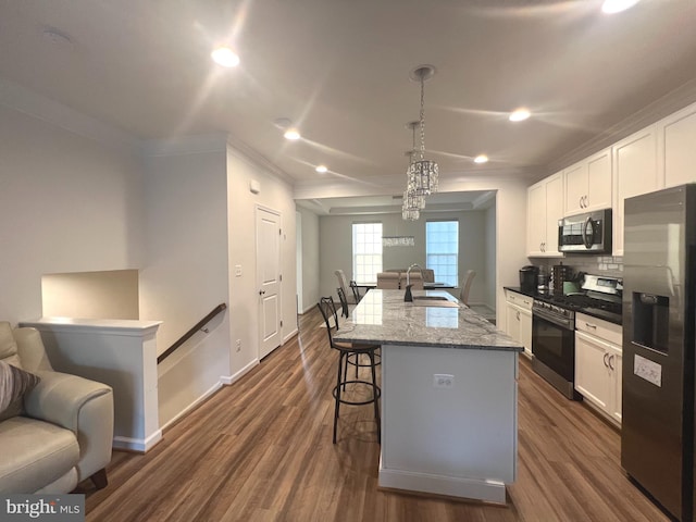 kitchen featuring sink, a center island with sink, pendant lighting, and appliances with stainless steel finishes