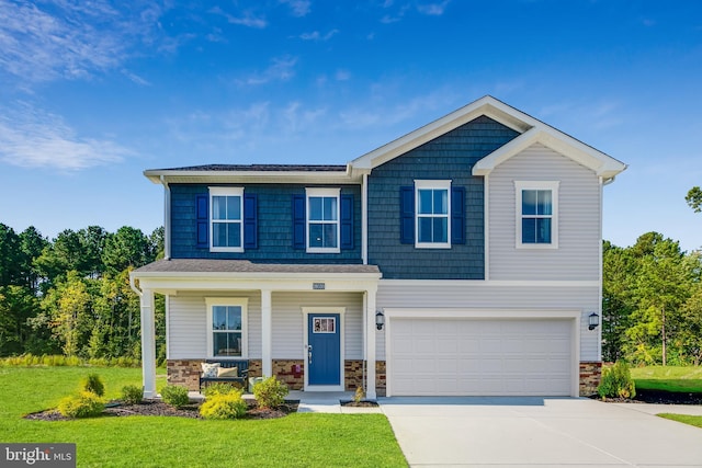 view of front of home with a front yard and a garage