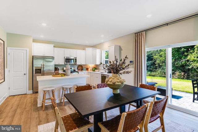 dining area featuring sink and light hardwood / wood-style flooring