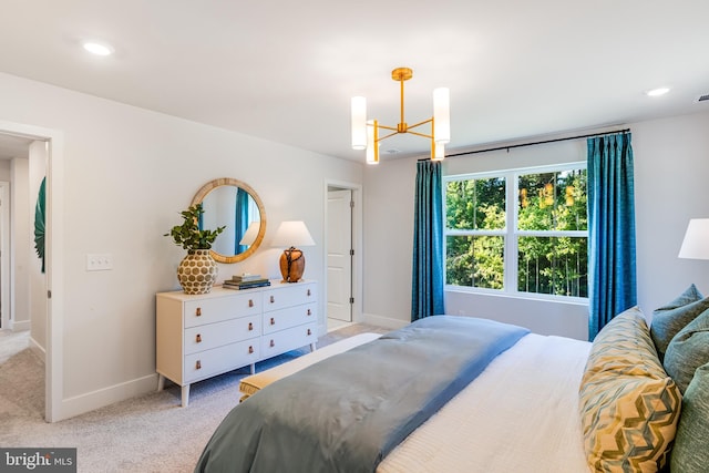 bedroom with a chandelier and light colored carpet