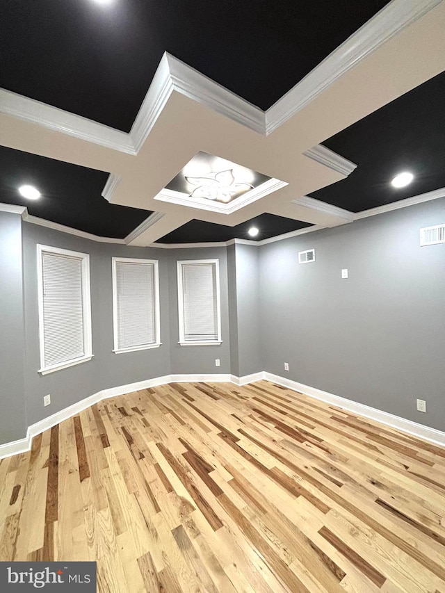 spare room featuring light hardwood / wood-style flooring, coffered ceiling, and ornamental molding