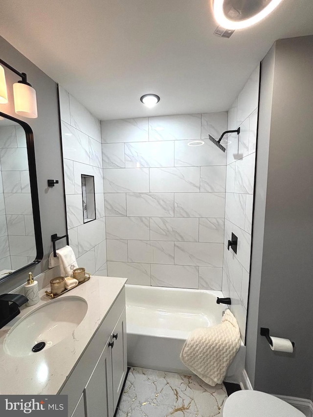 full bathroom with tiled shower / bath combo, toilet, and vanity