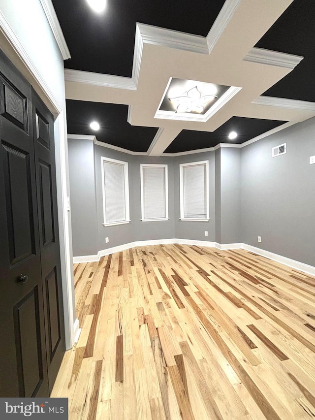 interior space with light hardwood / wood-style flooring and ornamental molding