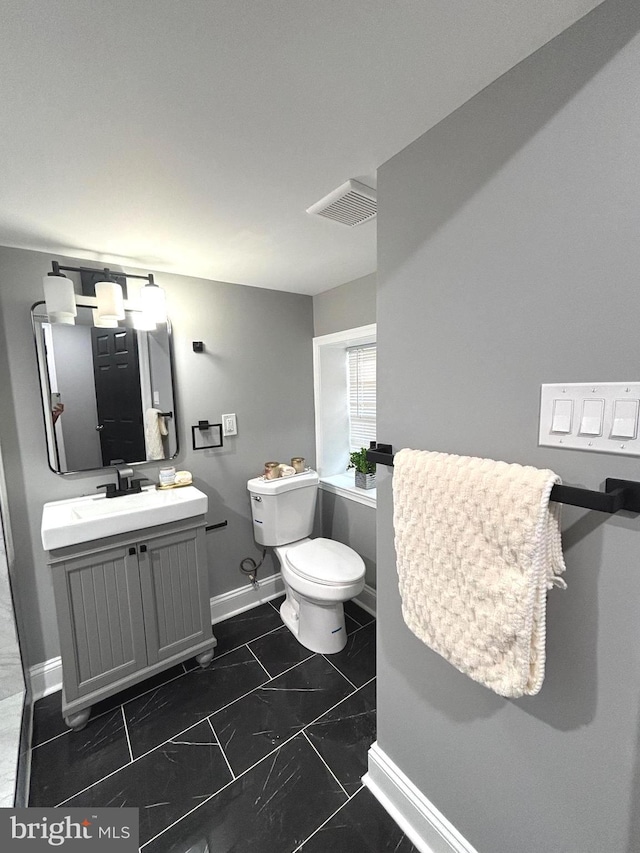 bathroom with vanity and toilet