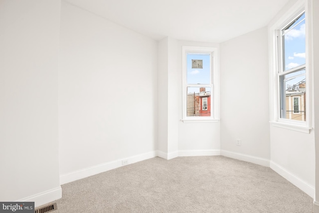 unfurnished room with light carpet