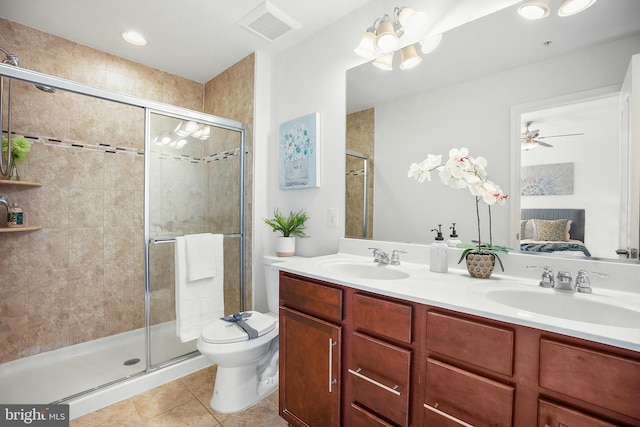 bathroom with tile patterned flooring, vanity, an enclosed shower, and ceiling fan