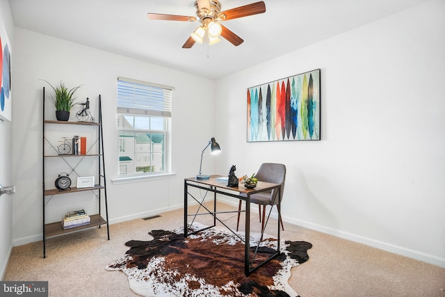 carpeted home office with ceiling fan