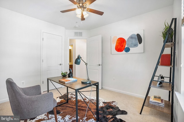 office space with ceiling fan and light colored carpet