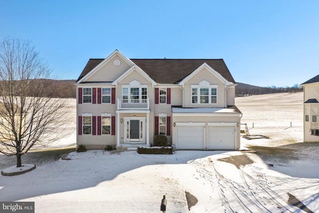 view of front of house featuring a garage and a balcony