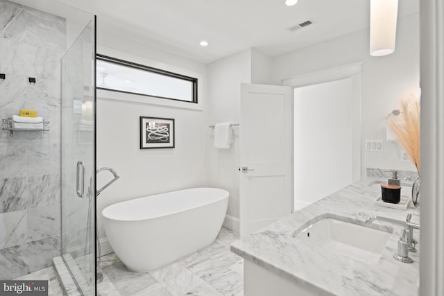 bathroom with marble finish floor, double vanity, a soaking tub, visible vents, and a sink