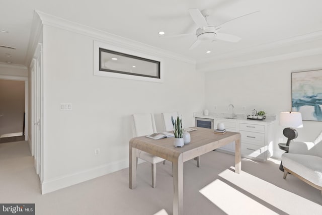 home office featuring recessed lighting, light carpet, crown molding, and a sink