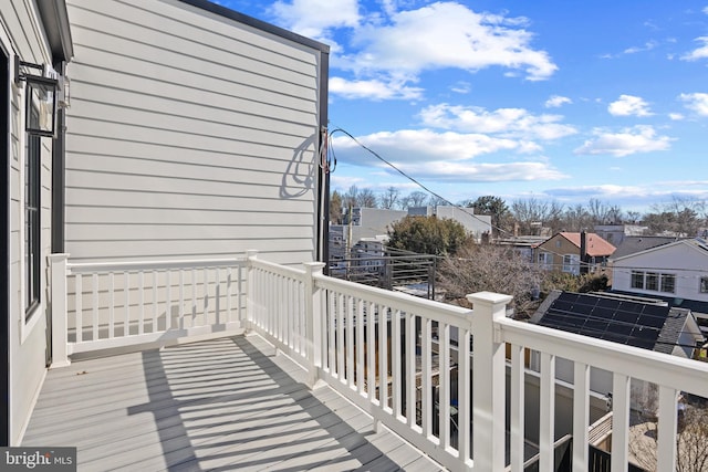 view of wooden balcony featuring a residential view and a deck