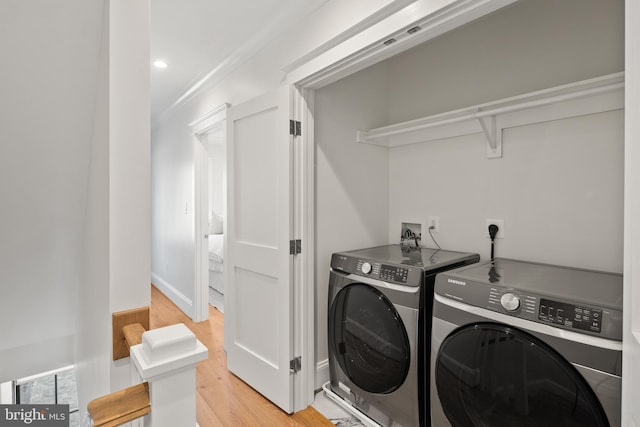 clothes washing area with recessed lighting, laundry area, baseboards, light wood-style floors, and washing machine and clothes dryer