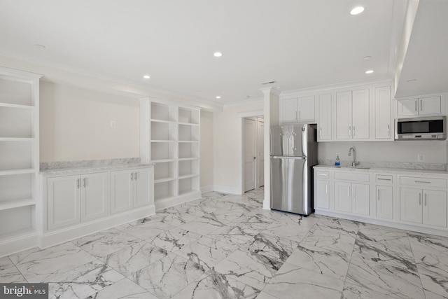 kitchen featuring ornamental molding, appliances with stainless steel finishes, recessed lighting, and white cabinets