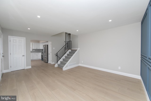 unfurnished living room with light wood-type flooring