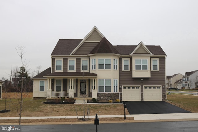 view of front of property with covered porch and a garage