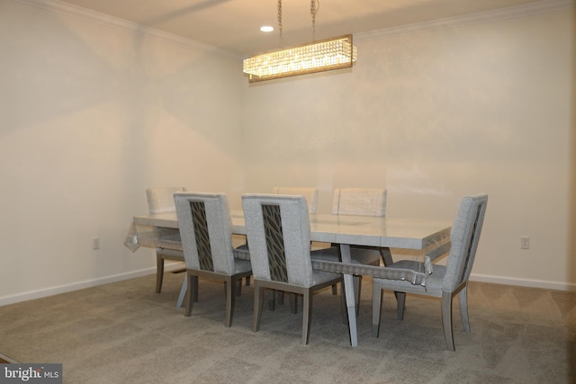 carpeted dining area with crown molding