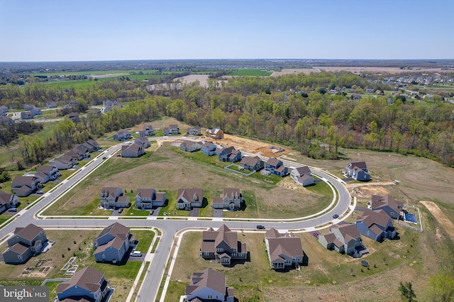 birds eye view of property featuring a residential view and a wooded view