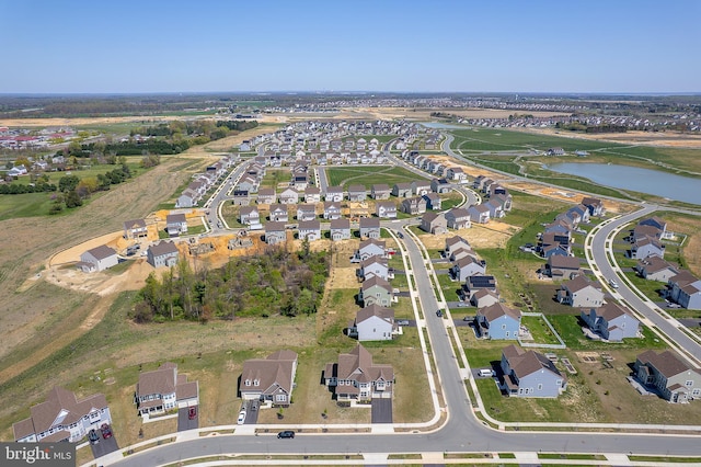 birds eye view of property featuring a water view and a residential view
