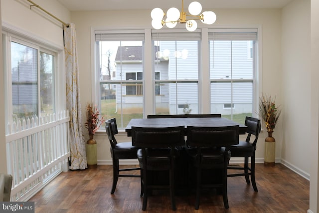 dining space with an inviting chandelier and dark wood-type flooring