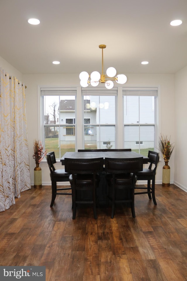 dining area featuring a notable chandelier and dark hardwood / wood-style flooring