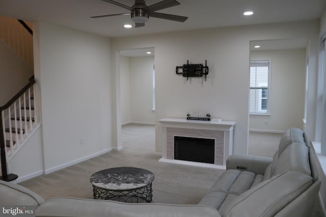 living room featuring ceiling fan and light colored carpet