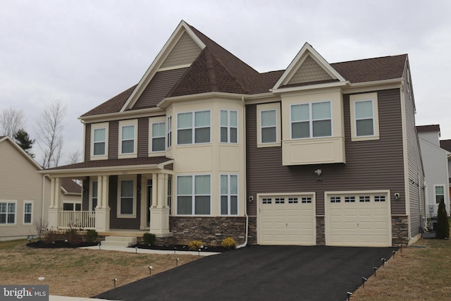 view of front of home with a porch and a garage