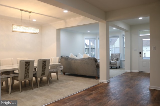 dining room with dark hardwood / wood-style floors and crown molding