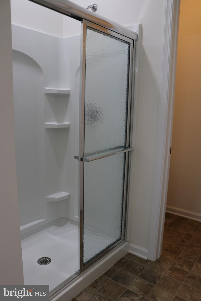 bathroom with a shower with shower door