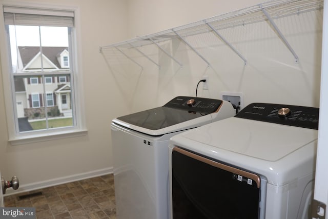 clothes washing area featuring separate washer and dryer