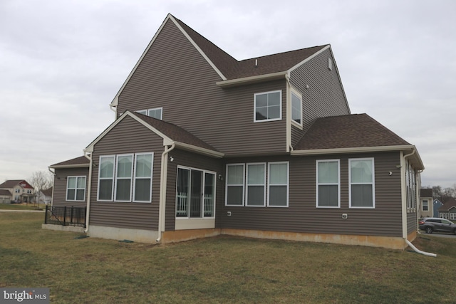 rear view of property featuring a yard