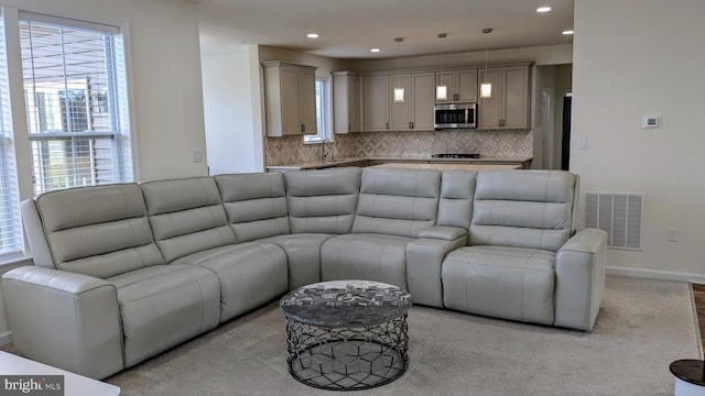 carpeted living room featuring sink