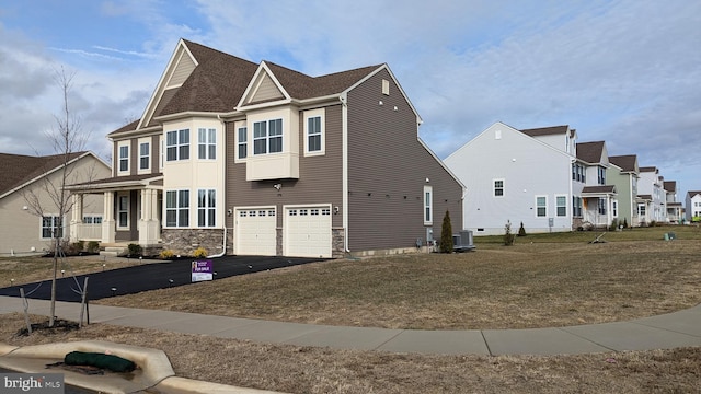 view of property exterior featuring a garage, cooling unit, and a lawn