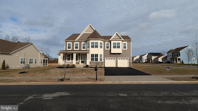 view of front facade featuring a porch and a garage