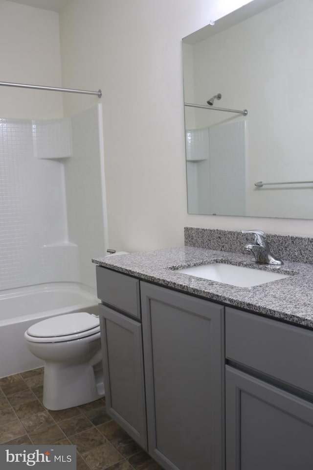 full bathroom with vanity,  shower combination, and toilet