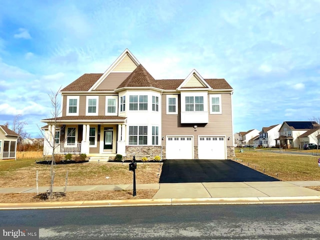 view of front of home featuring covered porch and a garage