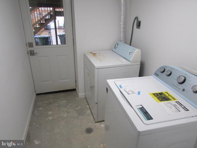 clothes washing area featuring washer and clothes dryer