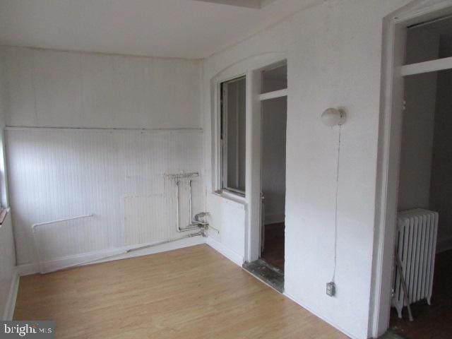 interior space with wood-type flooring and radiator