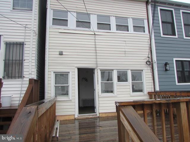 rear view of property featuring a deck