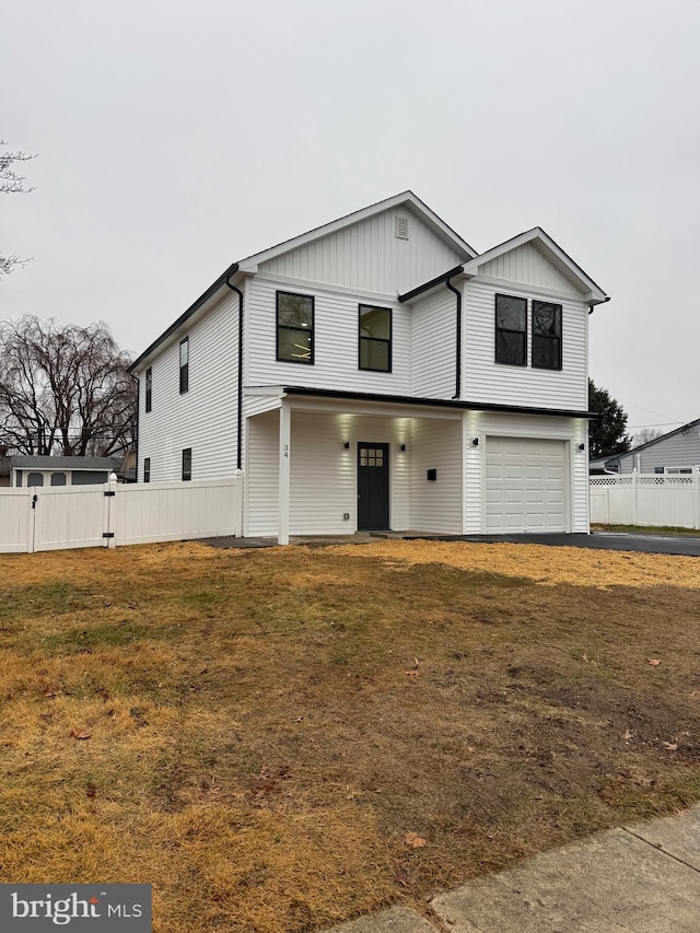 view of front of property with a garage and a front lawn