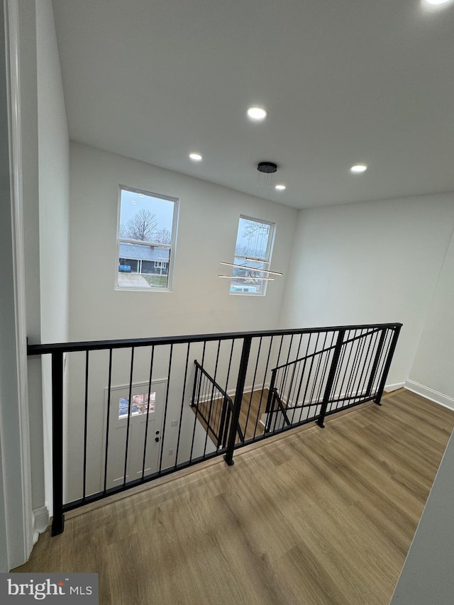 stairs featuring hardwood / wood-style floors