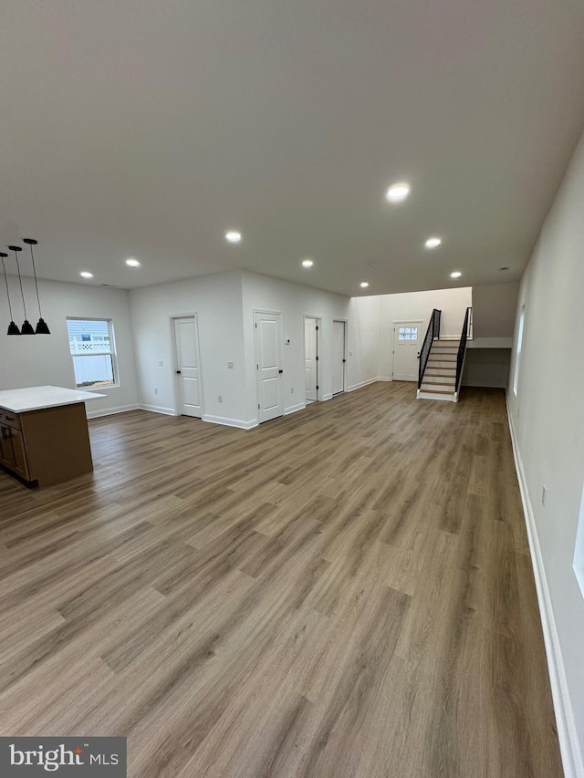 unfurnished living room featuring light wood-type flooring