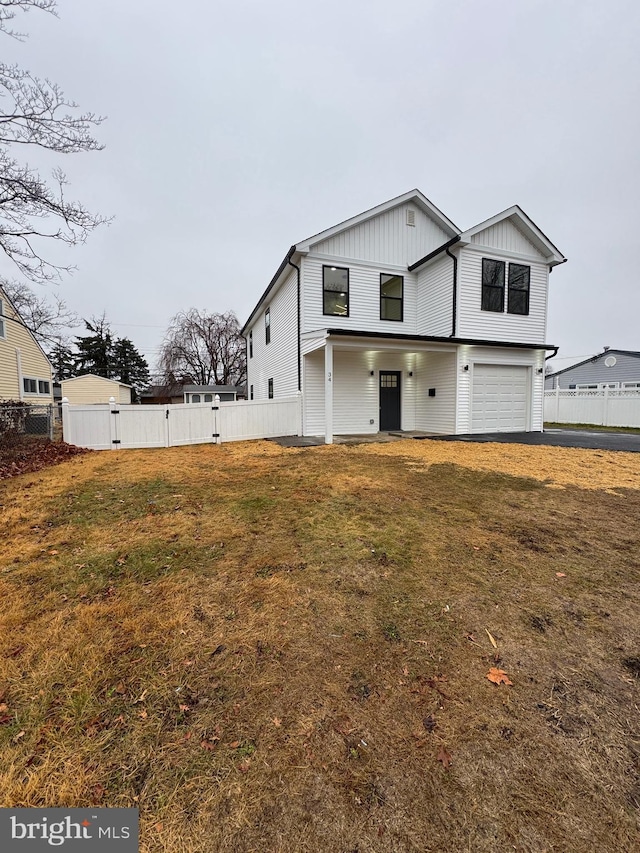 view of front of home with a garage and a front lawn