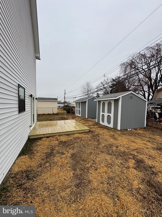 view of yard with a storage unit and a deck