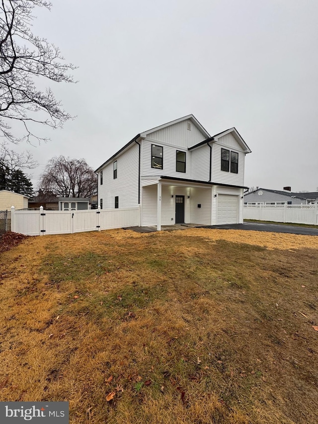 view of front of property with a garage and a front yard