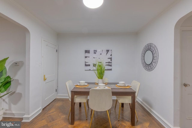 dining area with dark parquet floors