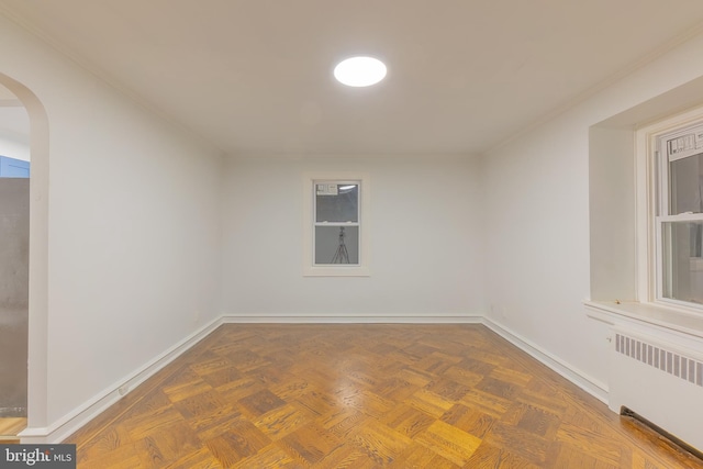 spare room with radiator heating unit and parquet floors